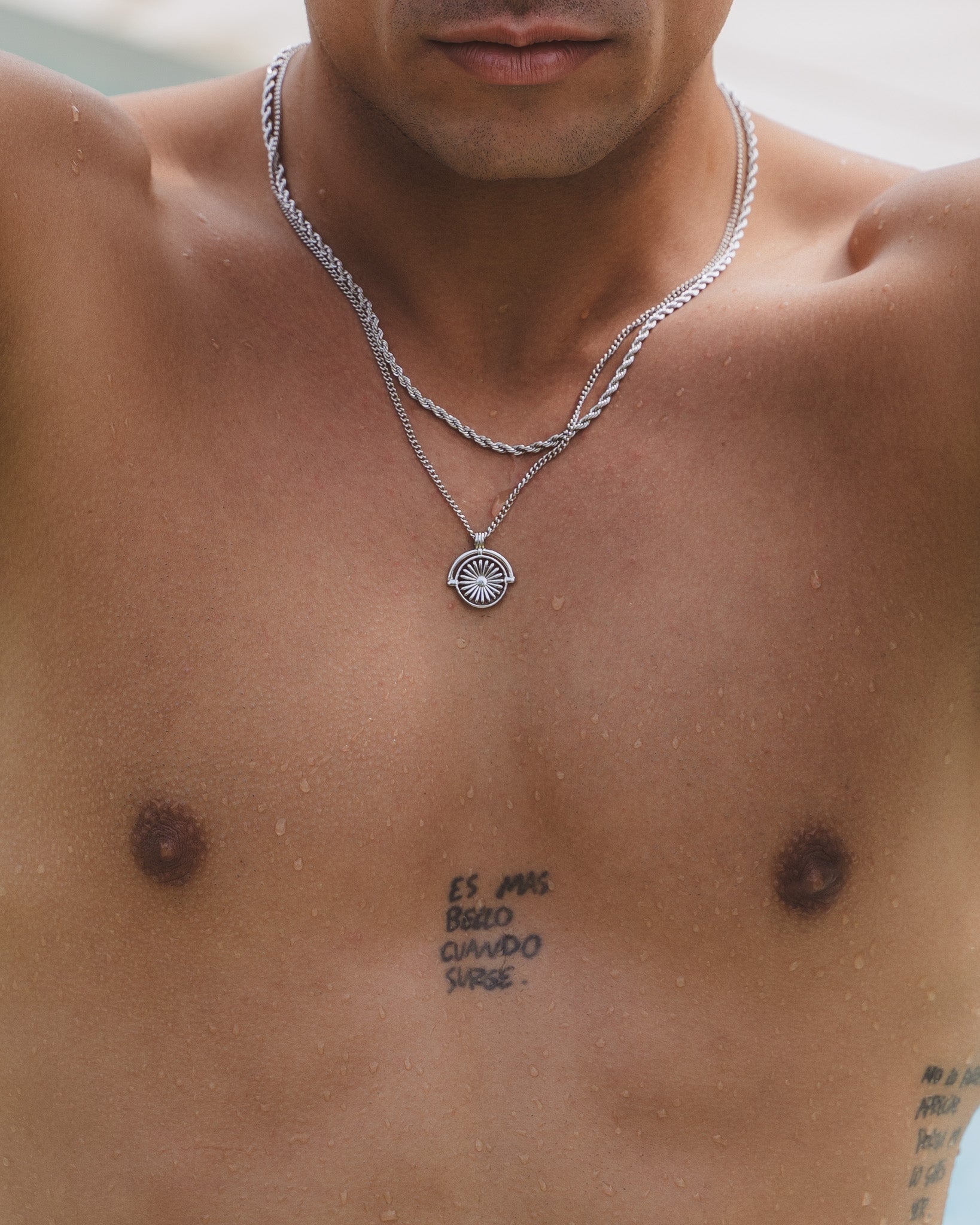 Closeup of a man wearing Lazio silver 3 mm rope chain around the neck with droplets on skin