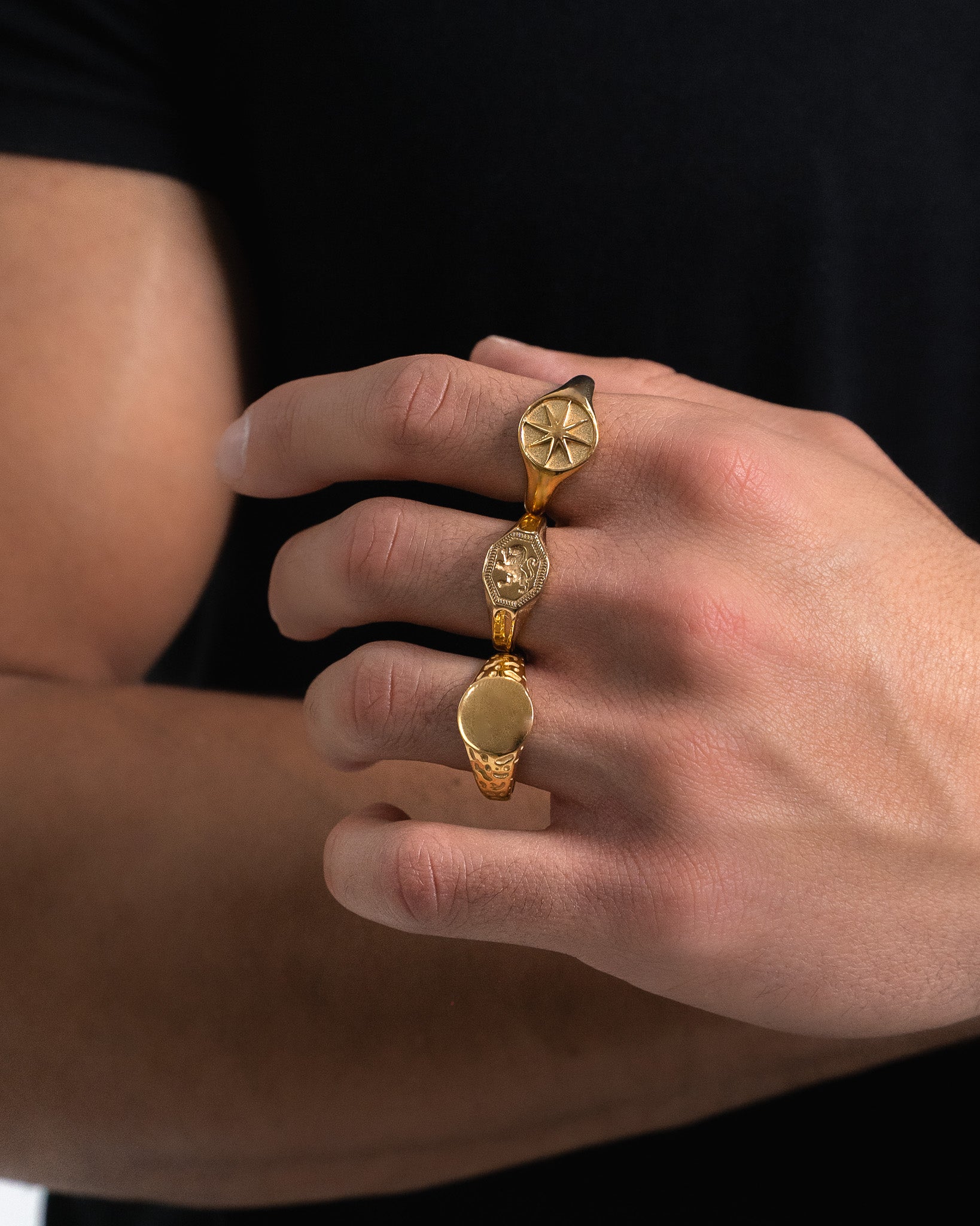 Gold star ring with star emblem on a finger