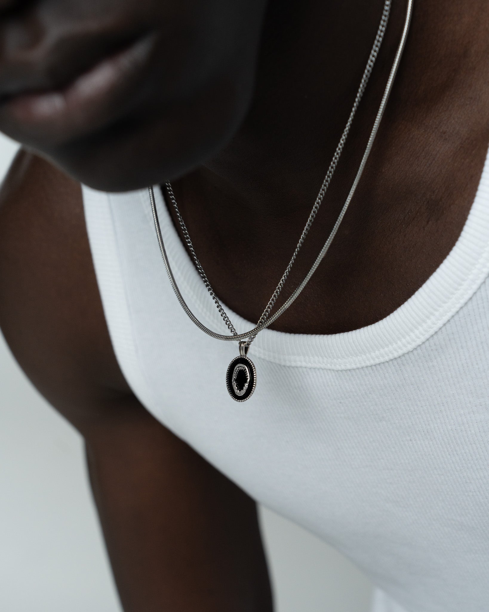 Lombok silver shark jaw pendant necklace on a person wearing a white top