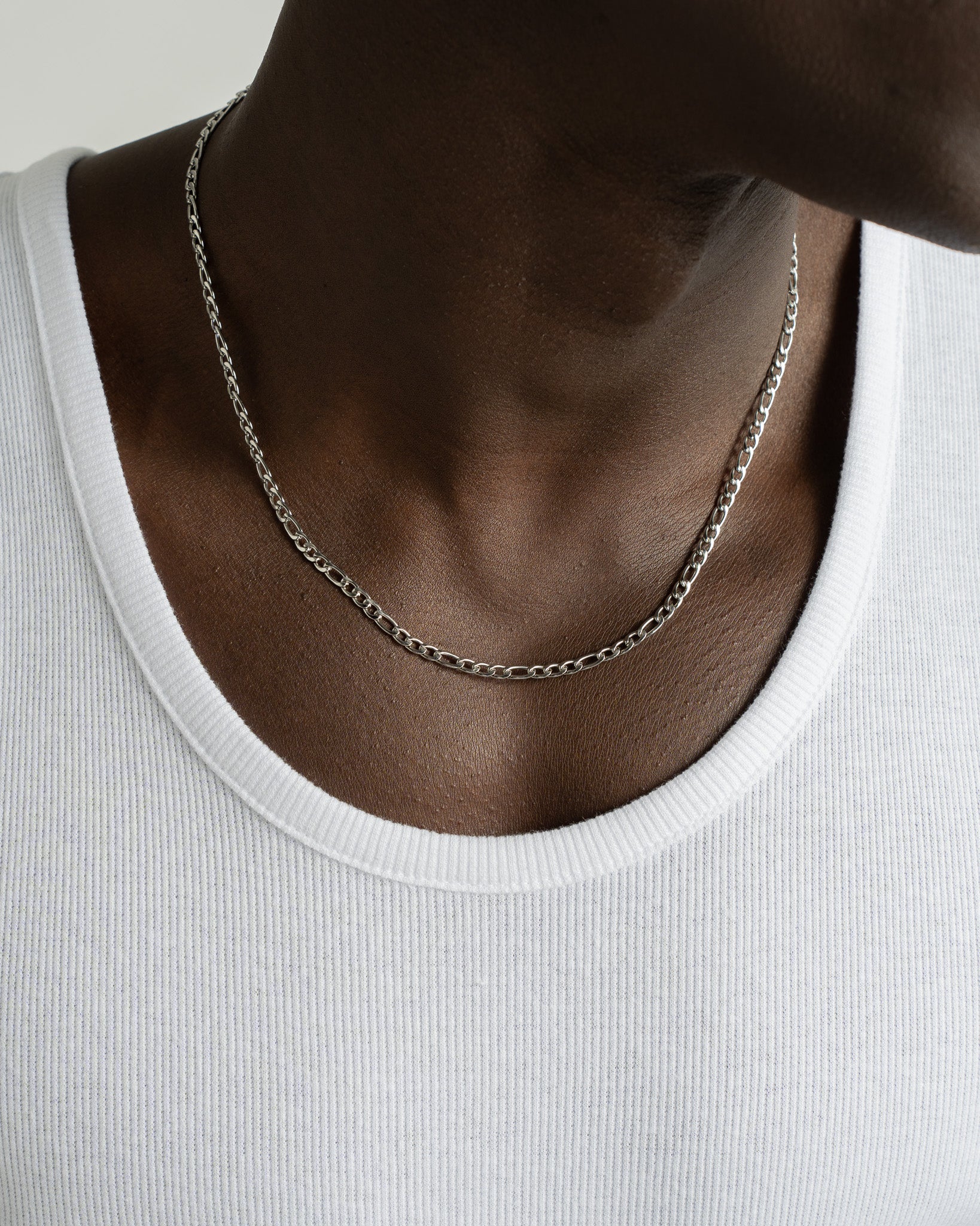 Amalfi Silver Chain worn on the neck over a white ribbed top.