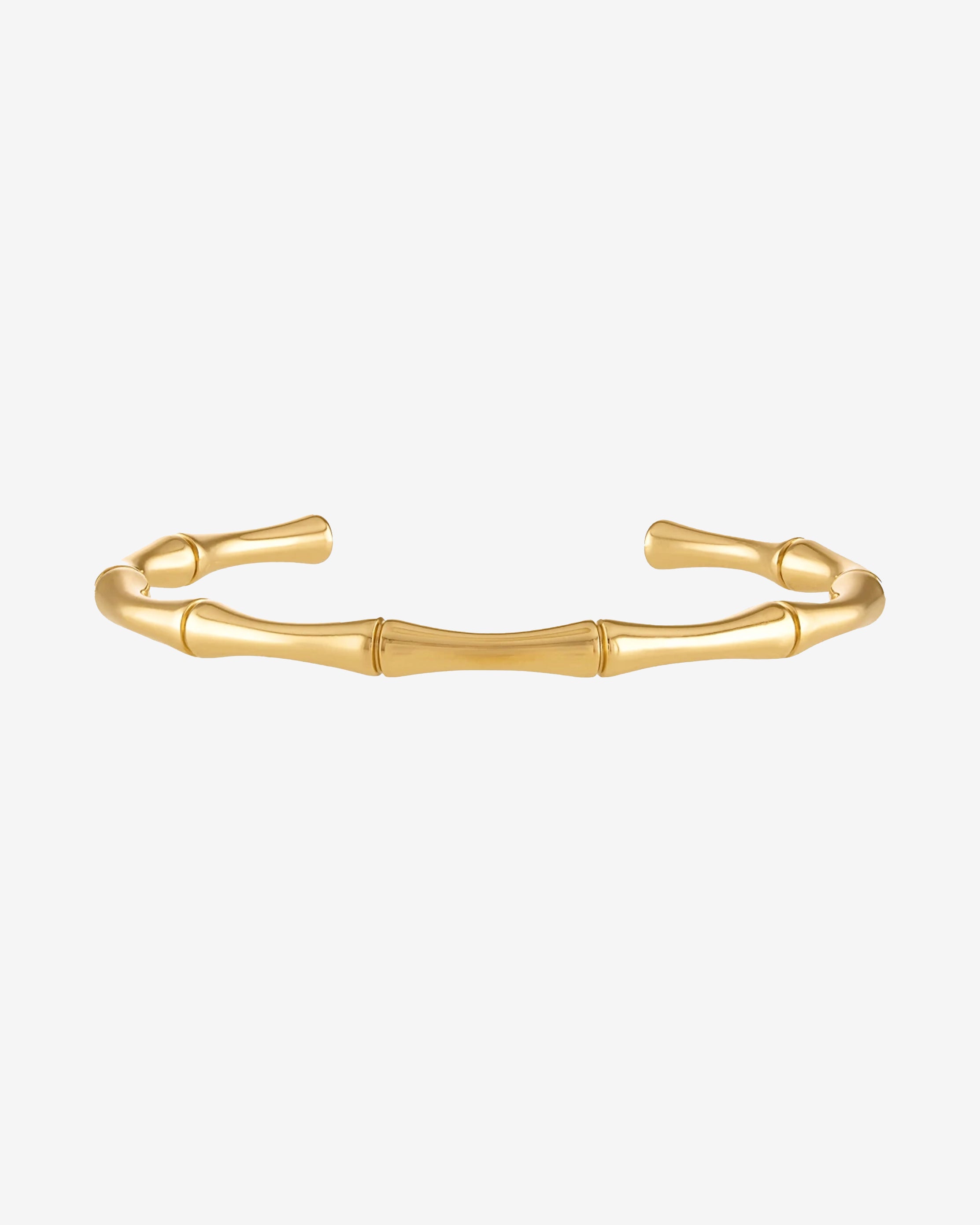 Gold bamboo bracelet with segmented links on a wrist.