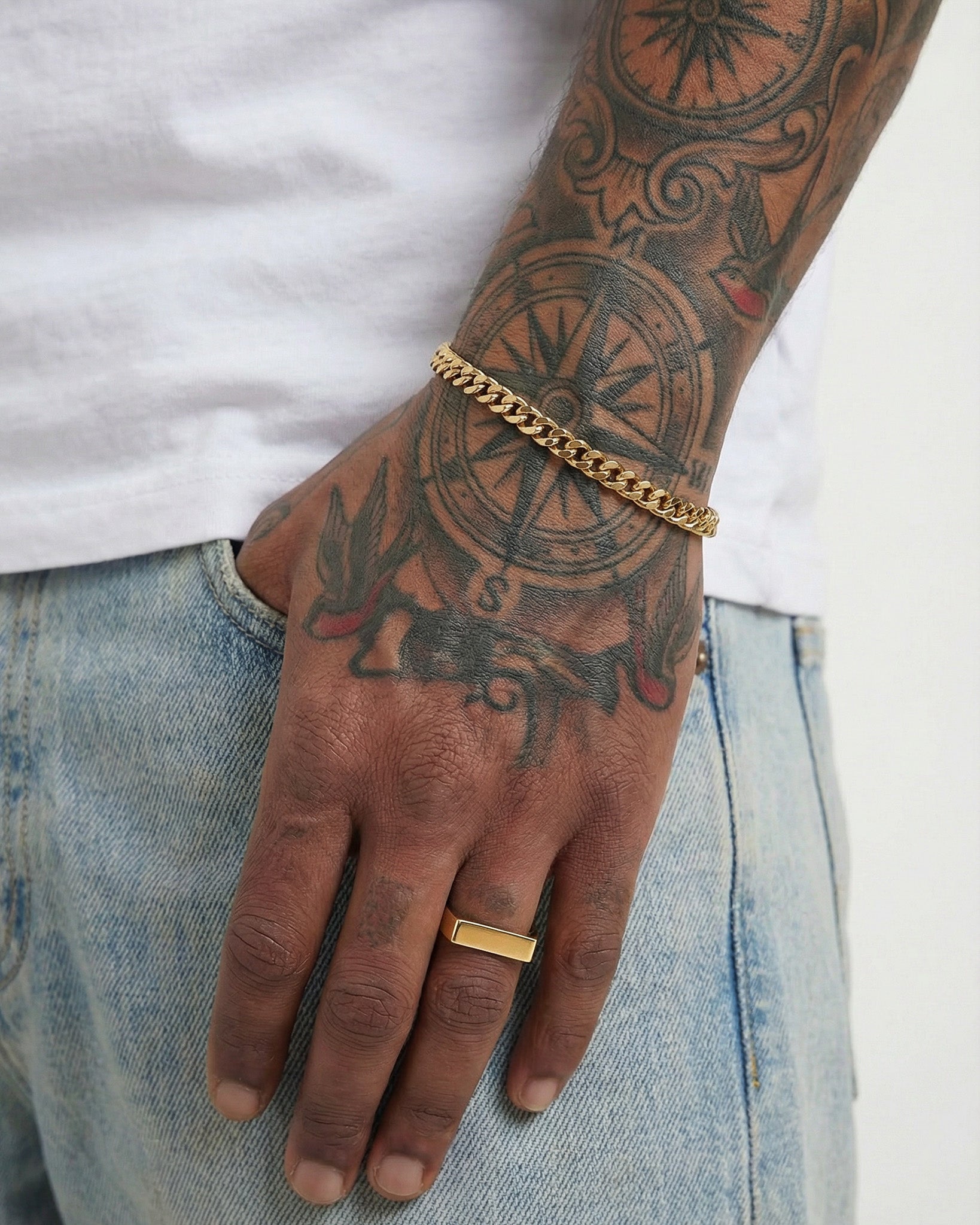 Gold Cuban link bracelet 5mm on a tattooed forearm