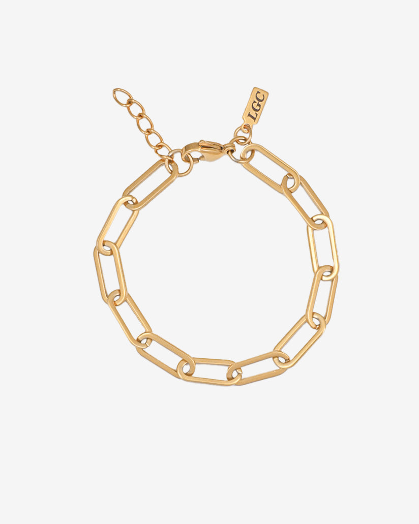 Debod gold bracelet with chunky rectangular links laid flat on a white background; adjustable length