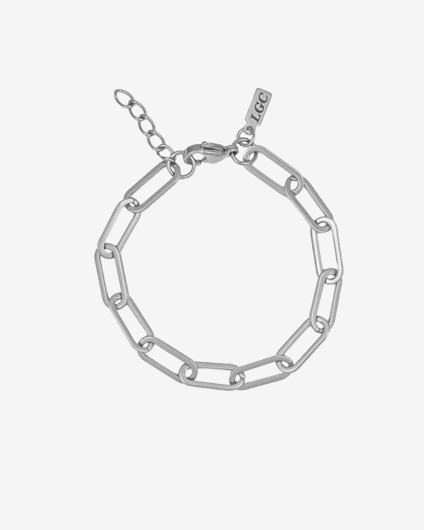 Silver bracelet with chunky elongated links and a small branding tag near the clasp
