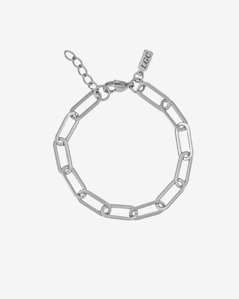 Silver bracelet with chunky elongated links and a small branding tag near the clasp