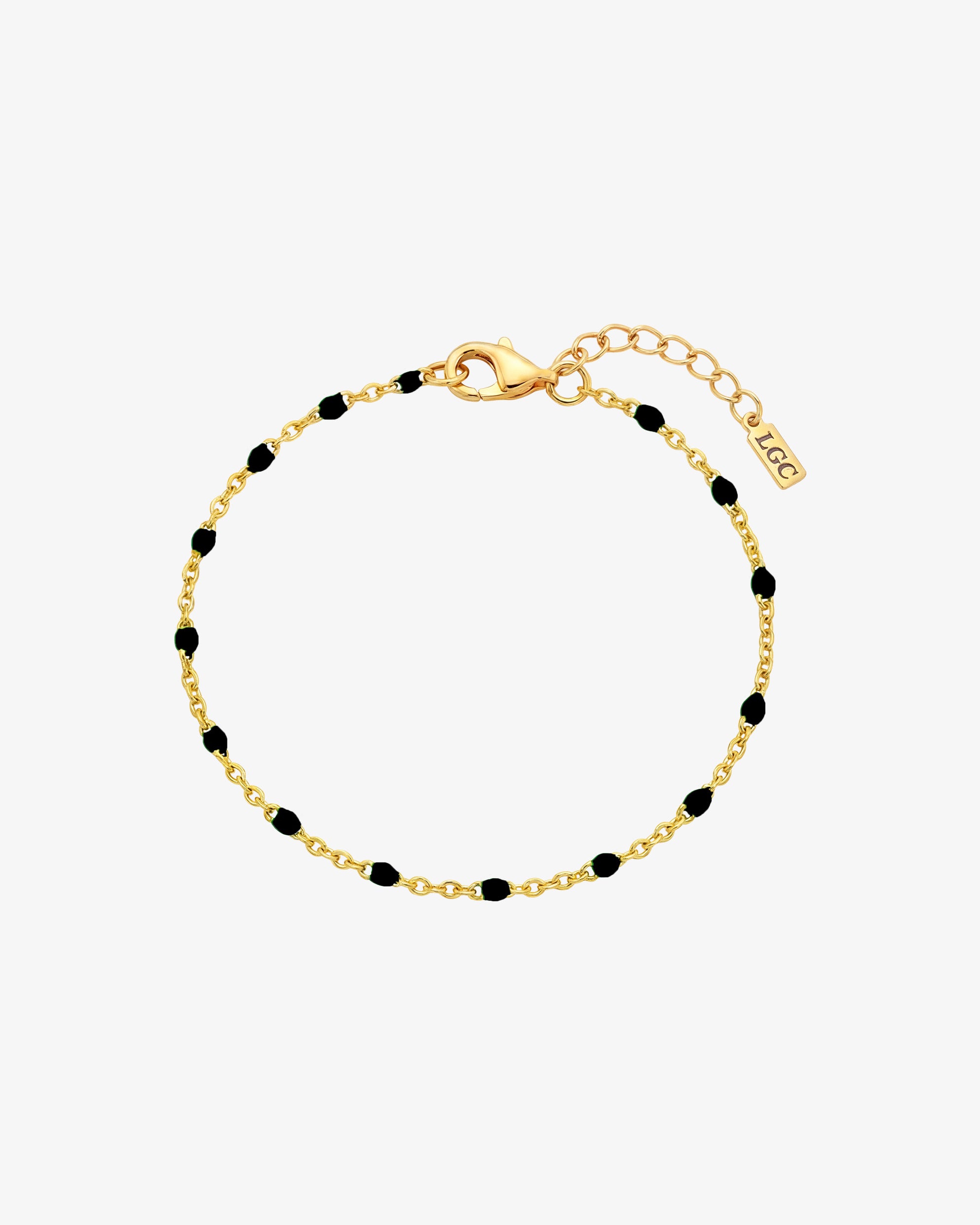 GEM gold bracelet with black beads along a gold chain and lobster clasp