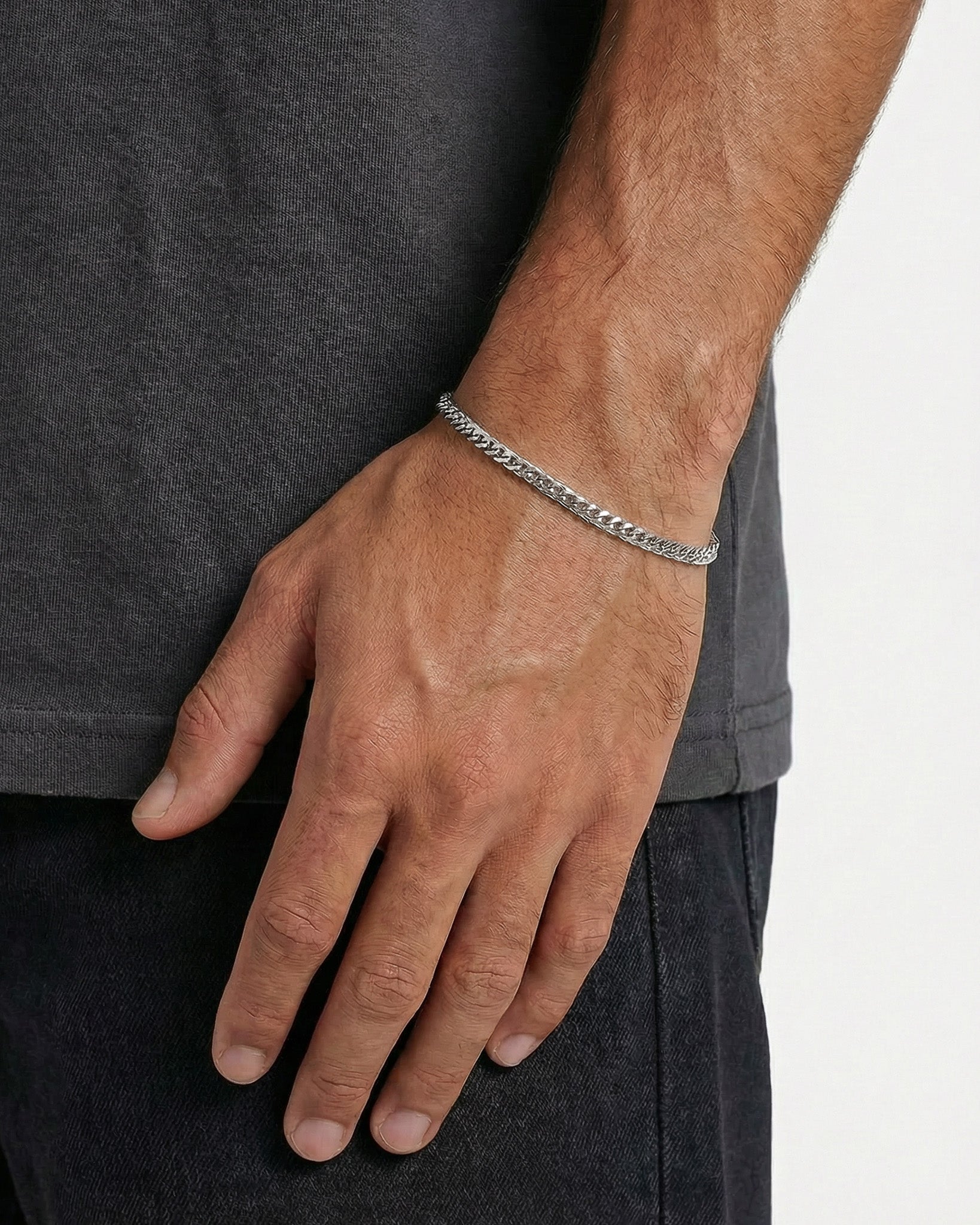 KUBU silver bracelet worn on the wrist, highlighting a minimalist Cuban link design