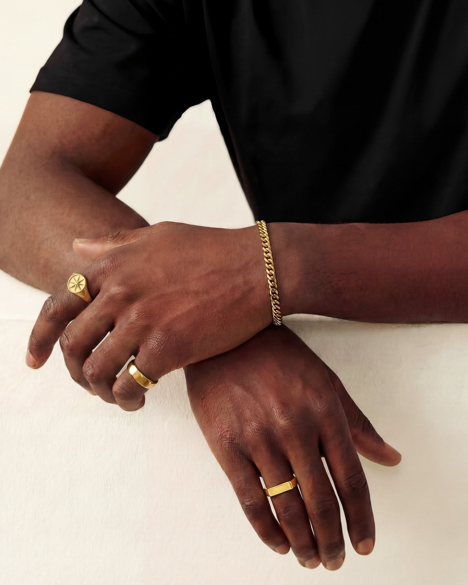 Gold Cuban link bracelet 5mm worn on a model's wrist
