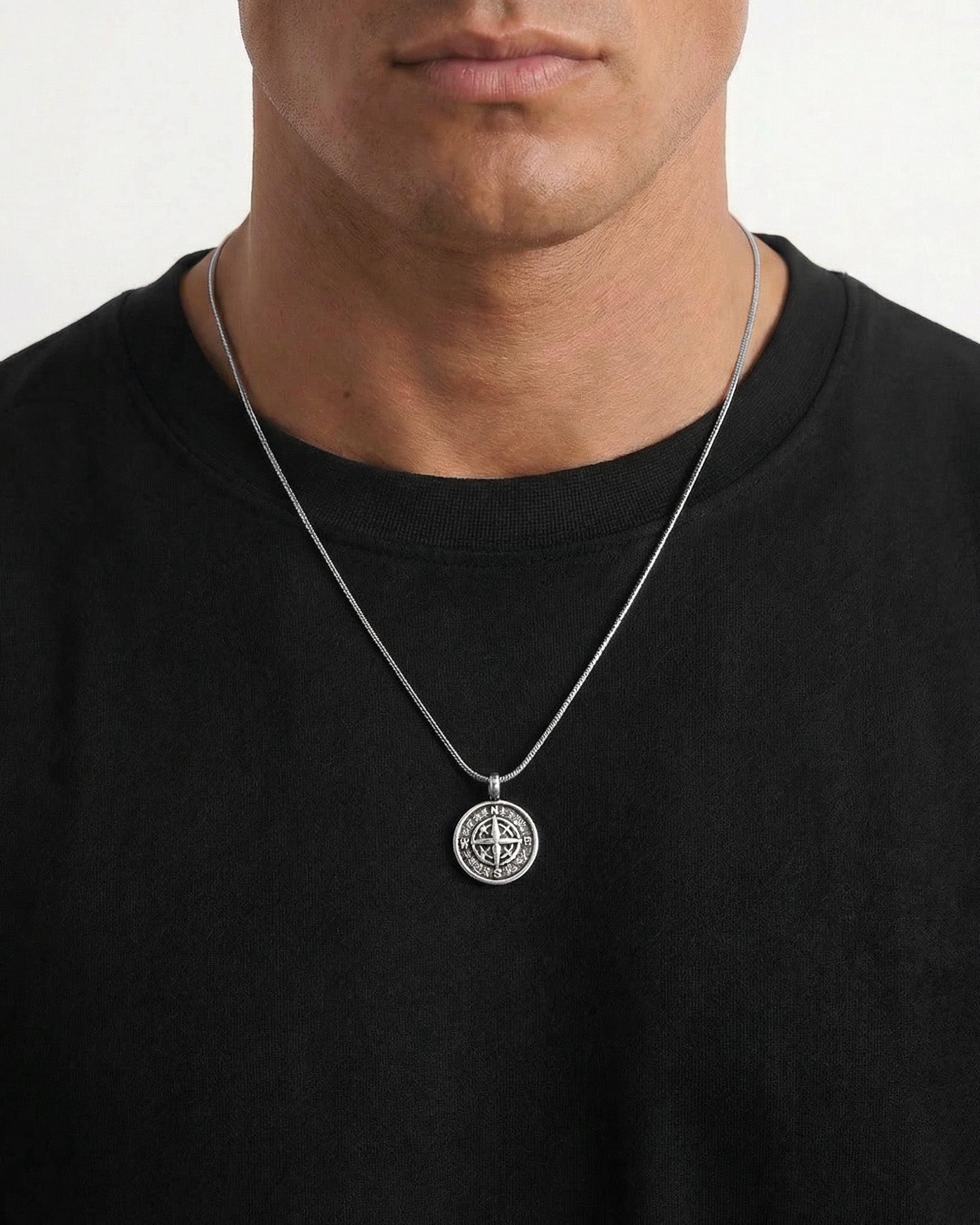 Model wears MOJAVE compass pendant necklace on a silver chain around the neck