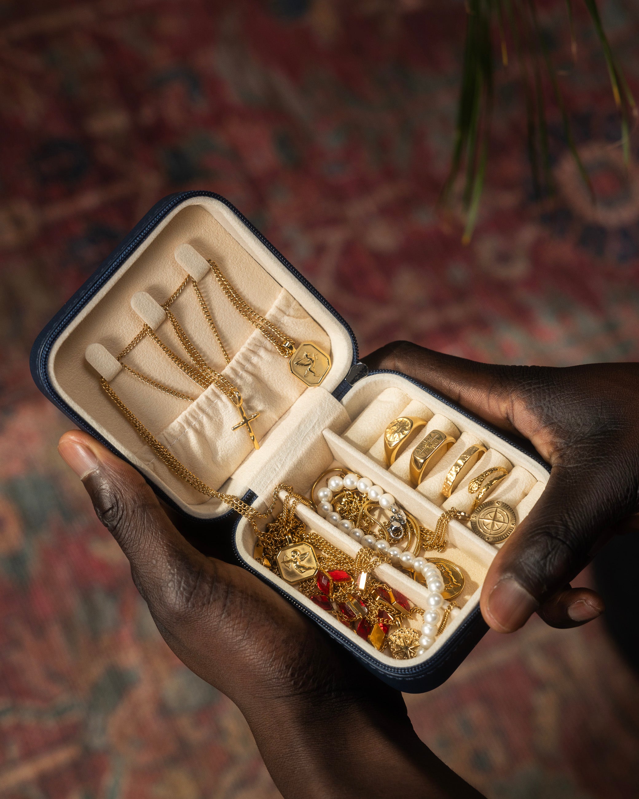 Open jewelry box from Build Your 7 Piece Box collection filled with gold rings chains and pearls