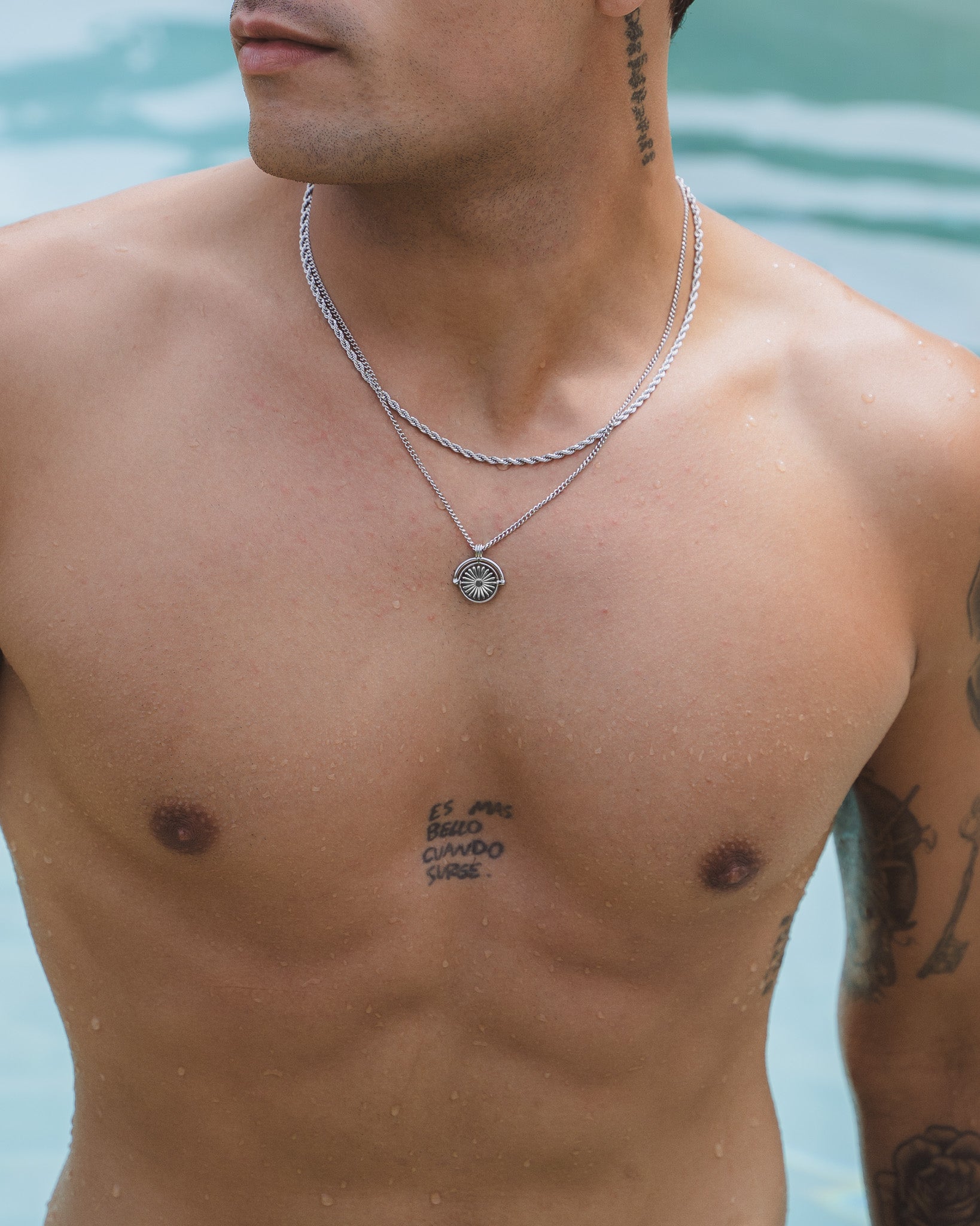 Two Lazio Silver Chain rope necklaces on a shirtless model with a round sunburst pendant on the lower chain