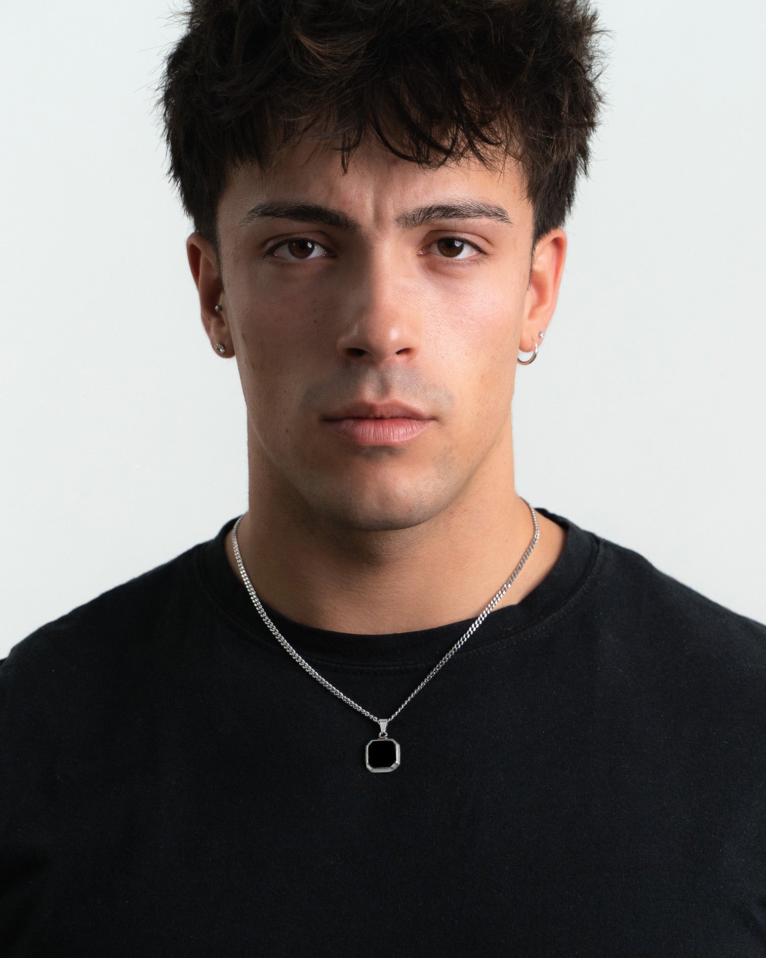 NOVA Silver Necklace worn by a man with the chain resting at the collarbone