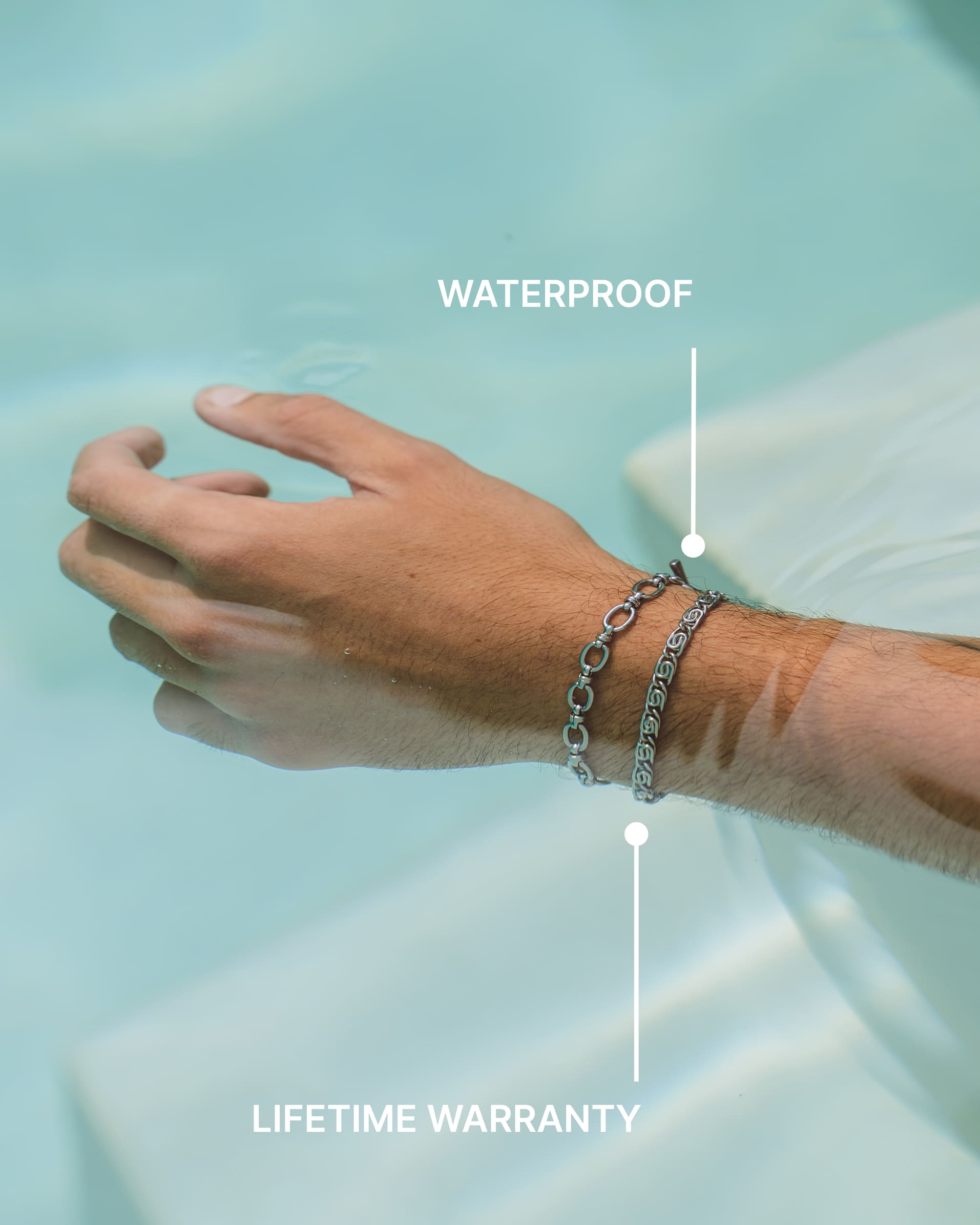 Wrist adorned with BYBLOS silver bracelet stack against blue water background