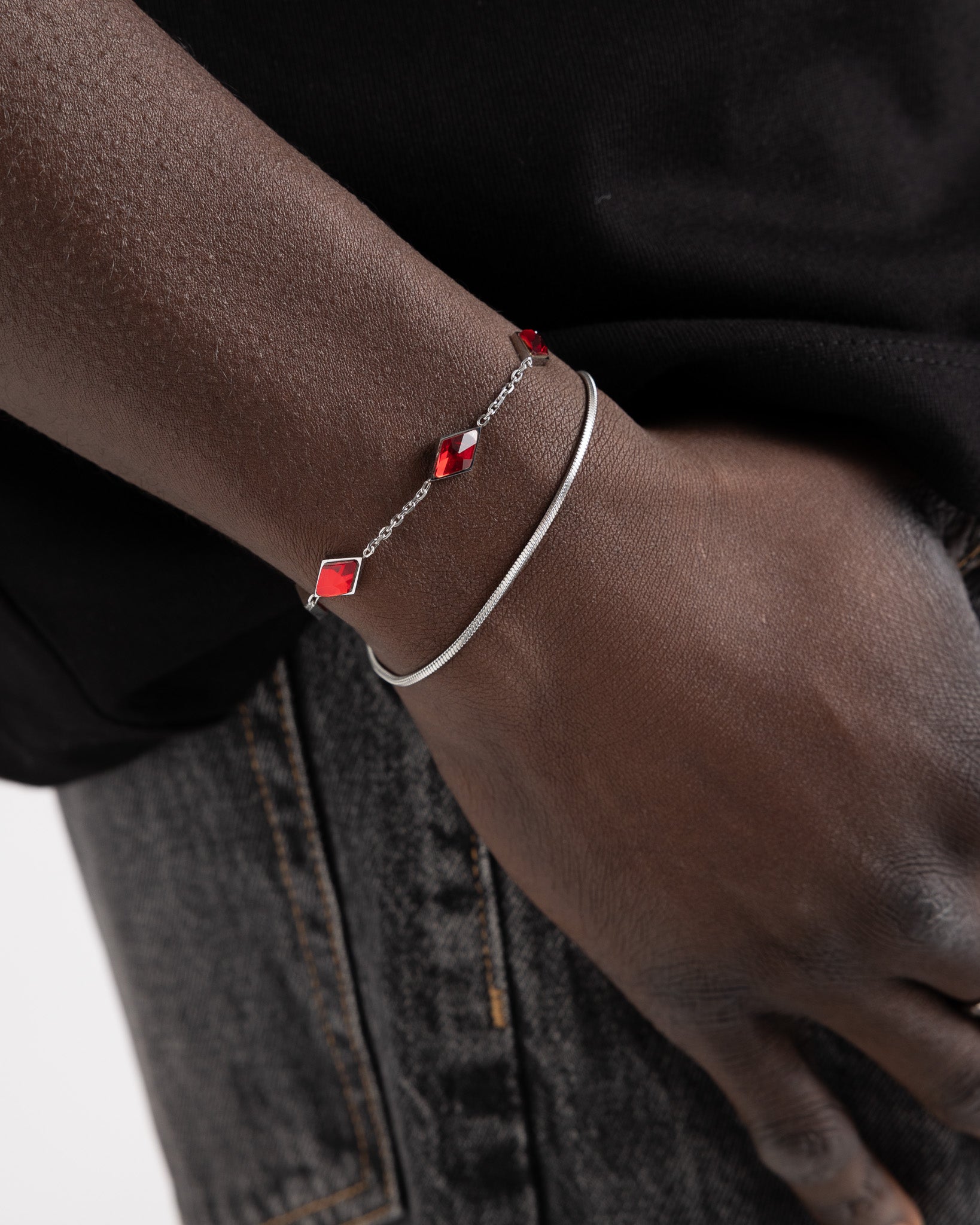 Amberes silver bracelet with a red square gemstone on a delicate chain worn on the wrist