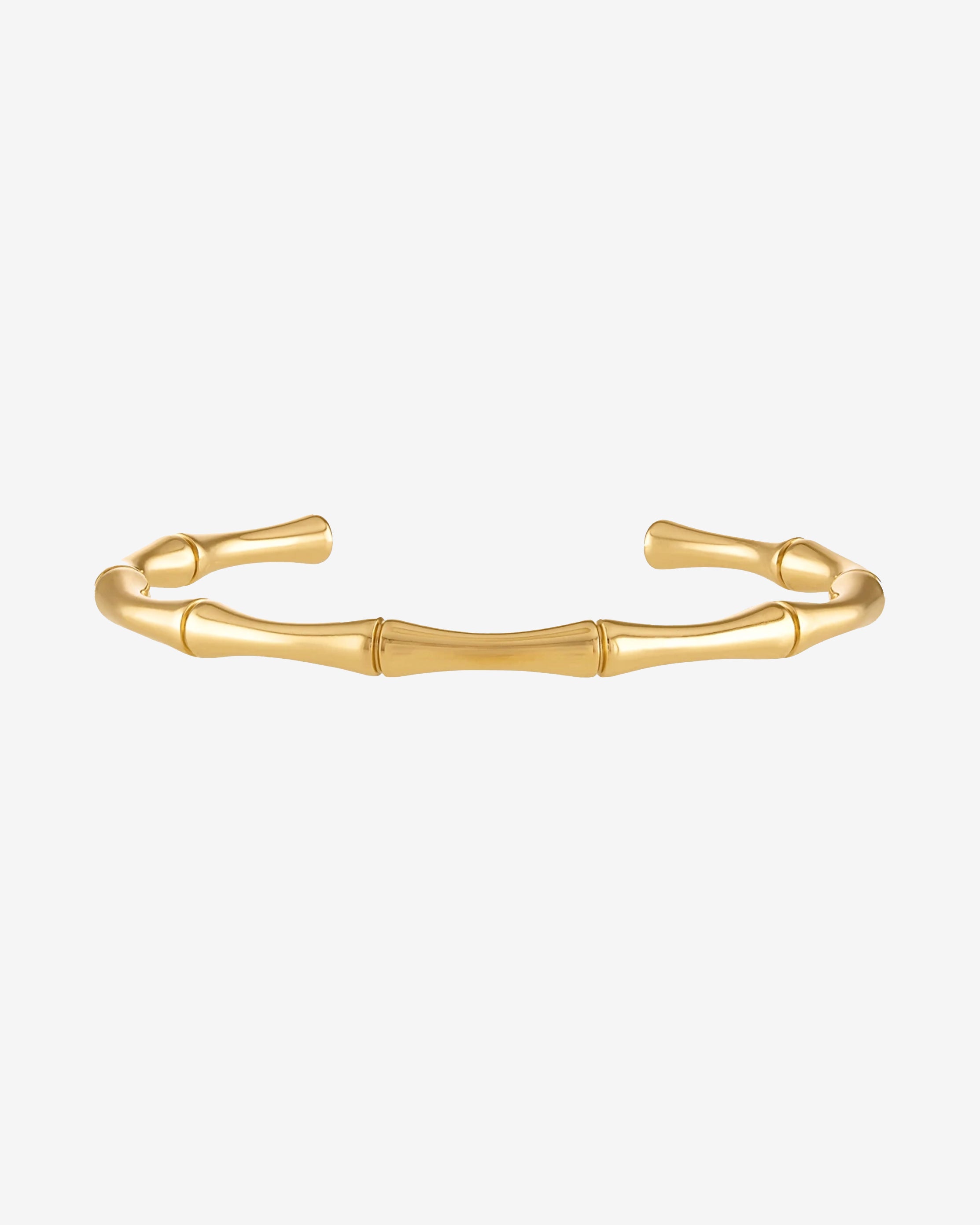 Gold bamboo bracelet with segmented links on a wrist.