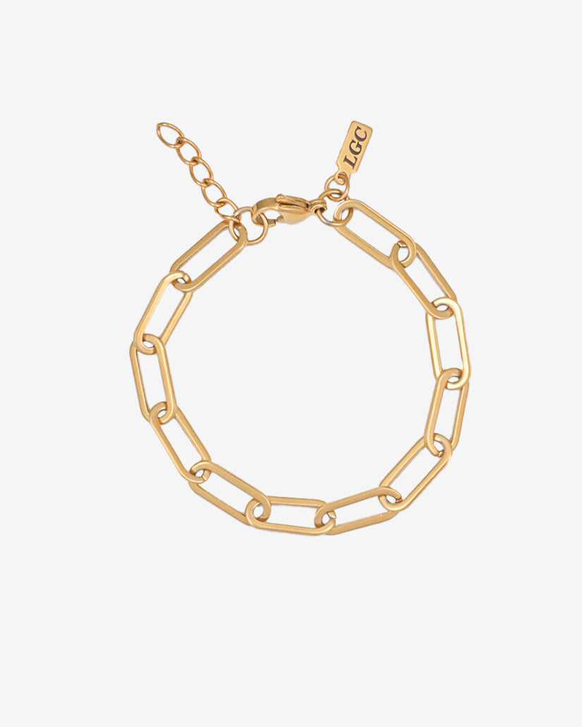 Debod gold bracelet with chunky rectangular links laid flat on a white background; adjustable length