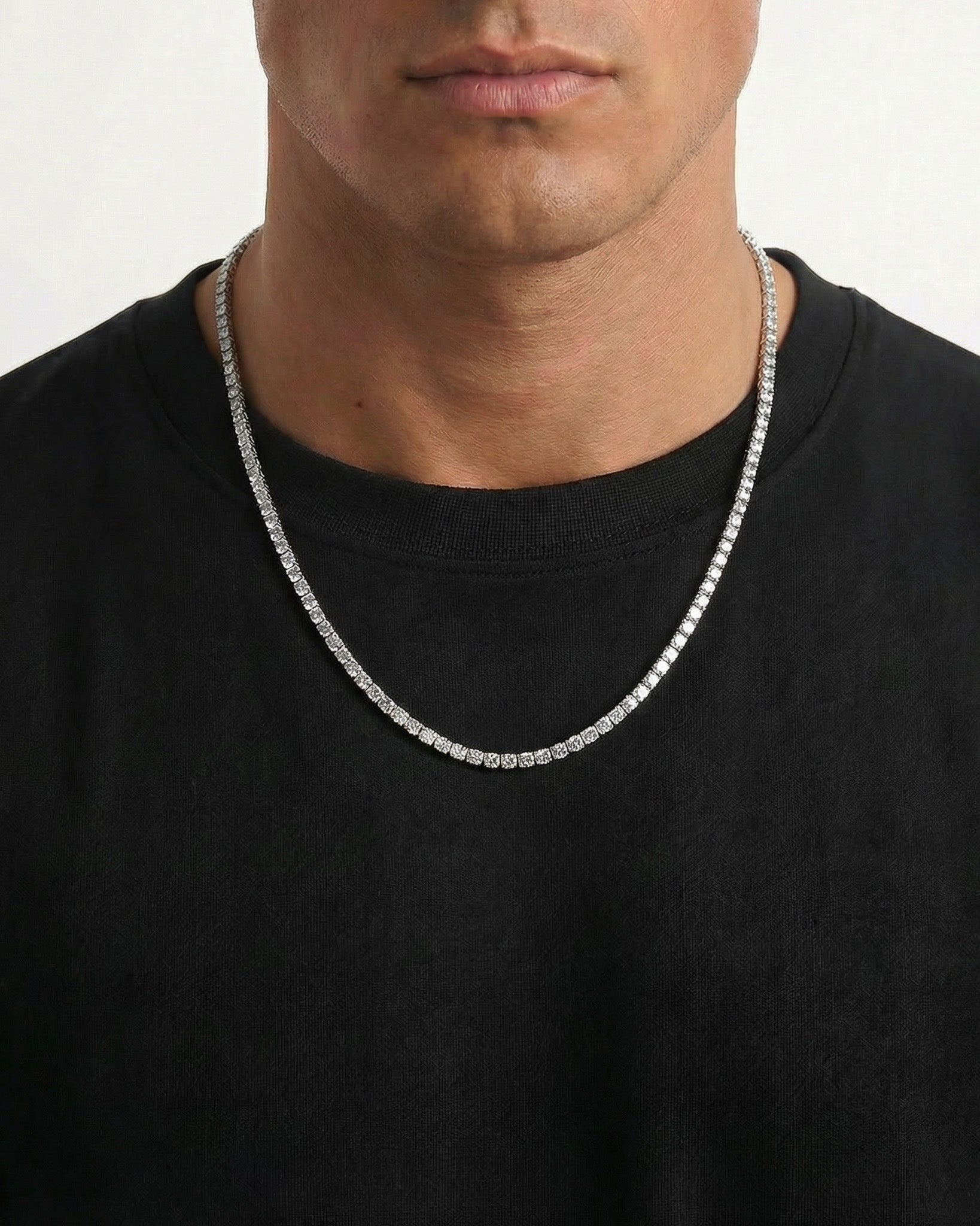 Model wearing the zircon tennis chain around the neck over a black shirt.