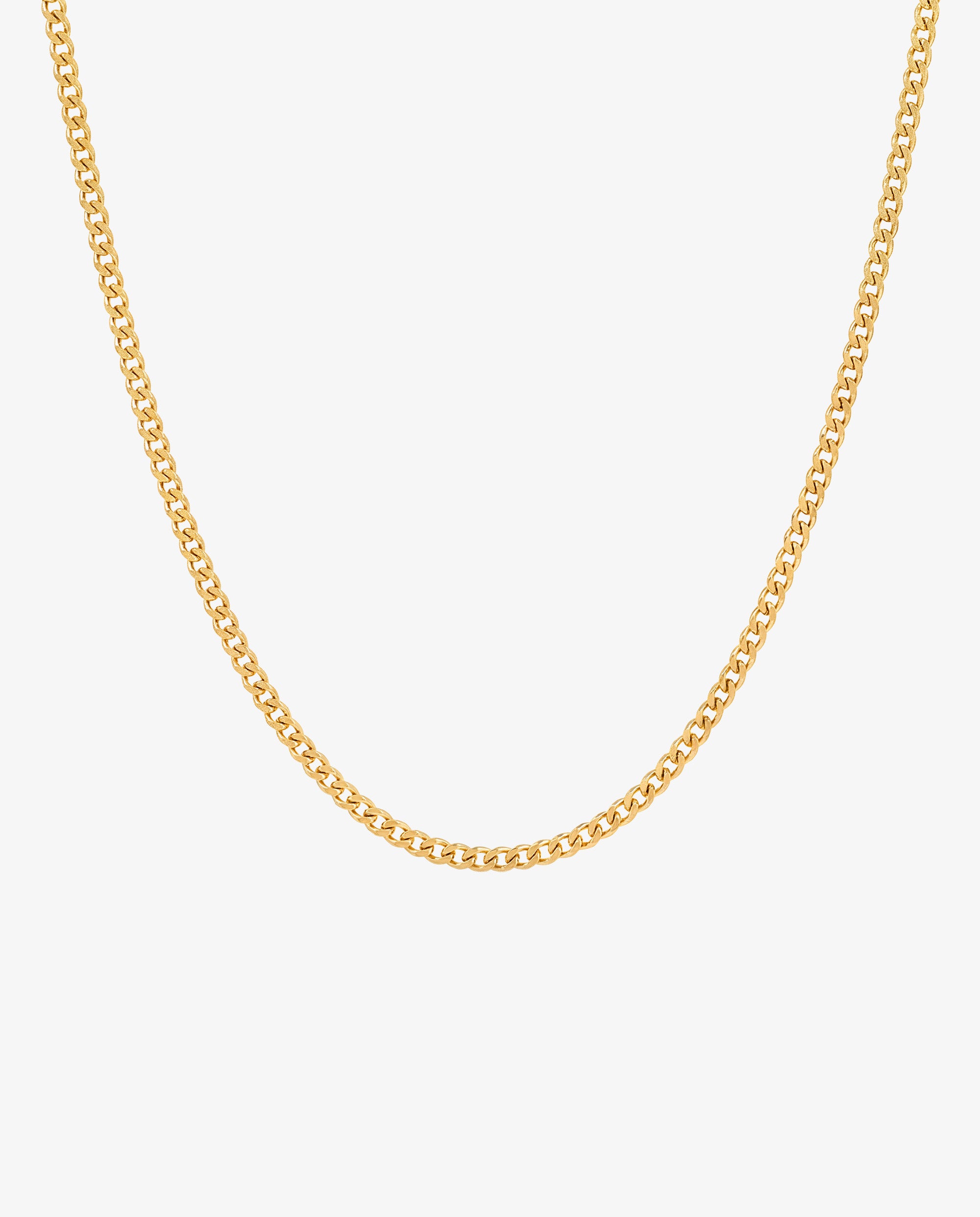 Close up of a minimalist 3 mm gold Cuban link chain
