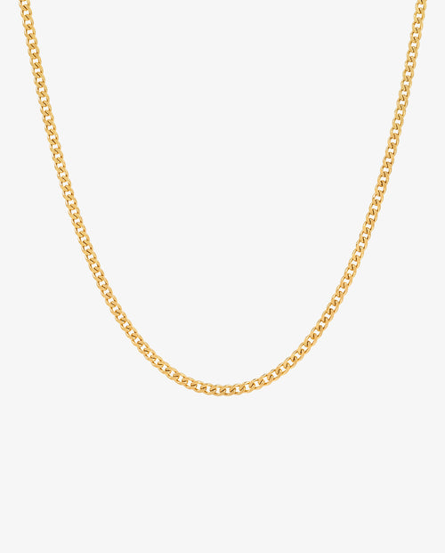 Close up of a minimalist 3 mm gold Cuban link chain