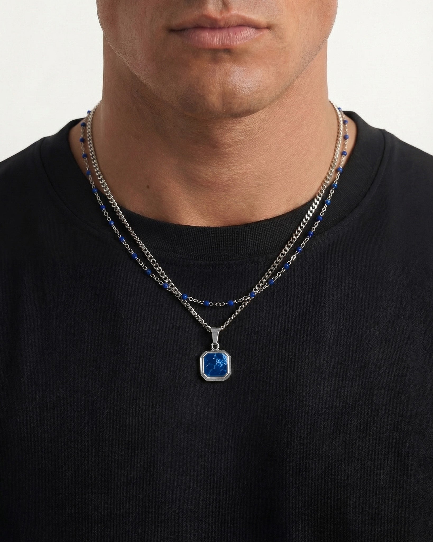Layered silver chain with blue beads and a blue stone pendant necklace