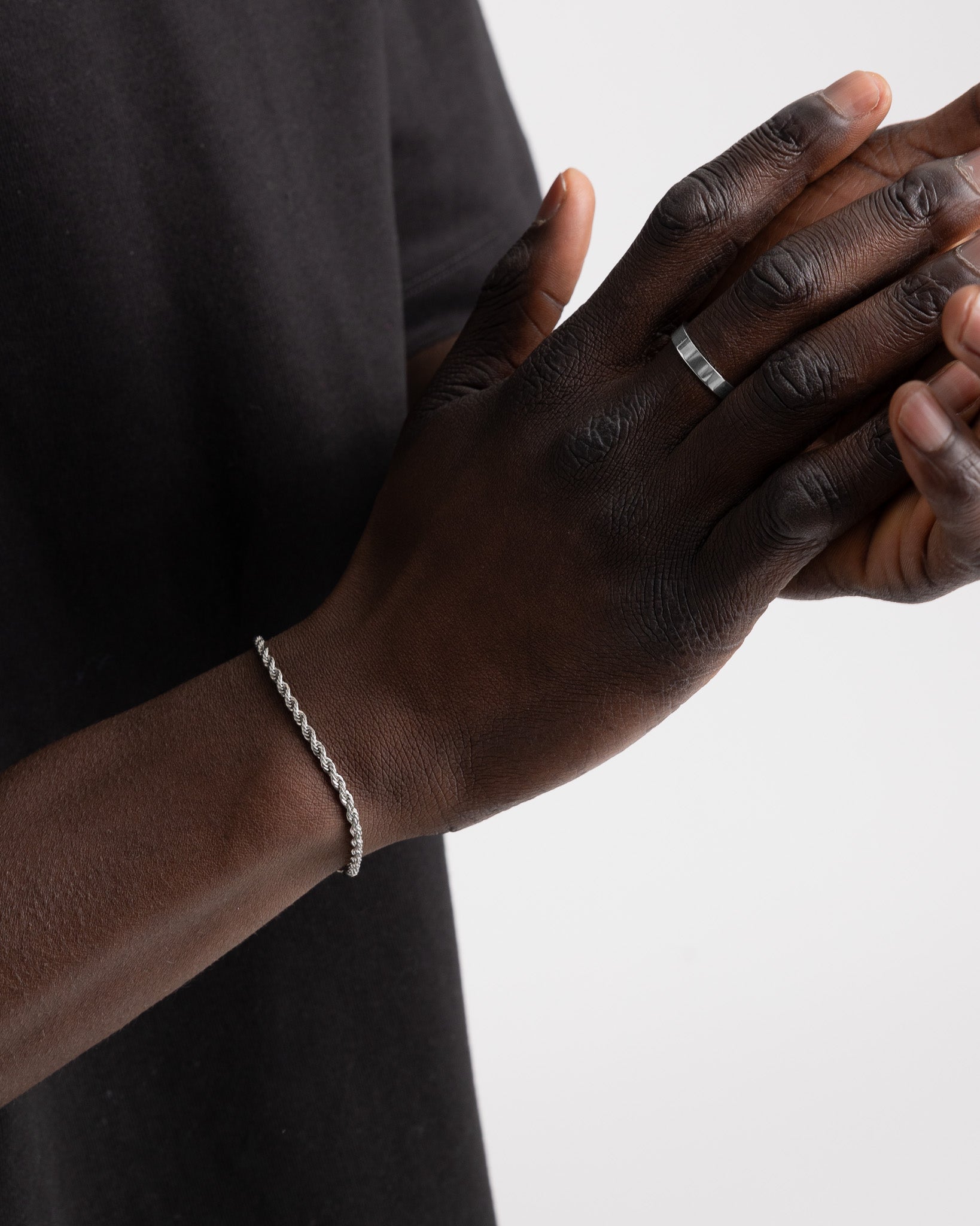 Lazio Silver Bracelet on the wrist with a visible ring, showcasing a refined rope chain.