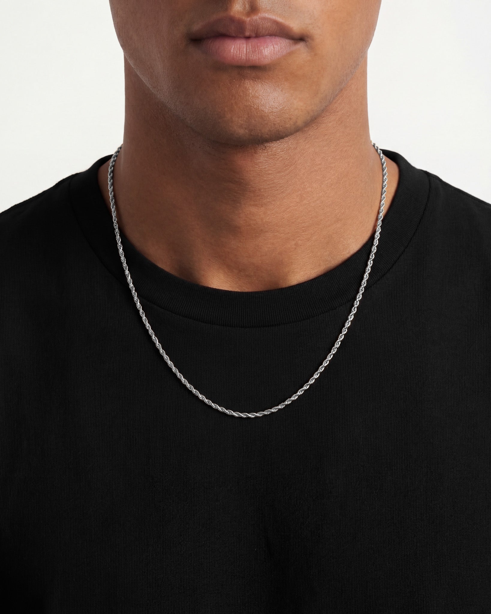 Lazio Silver Chain worn by a male model around the neck, close up over a black shirt