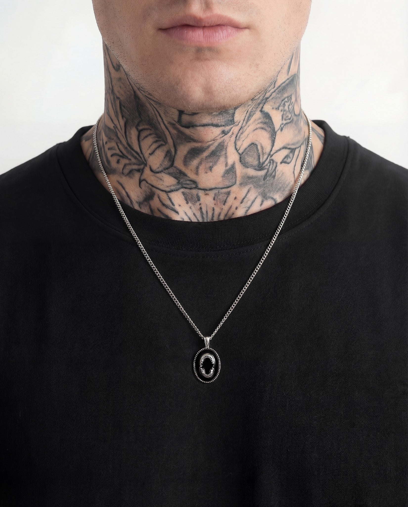 Lombok silver shark jaw pendant necklace worn on a tattooed neck