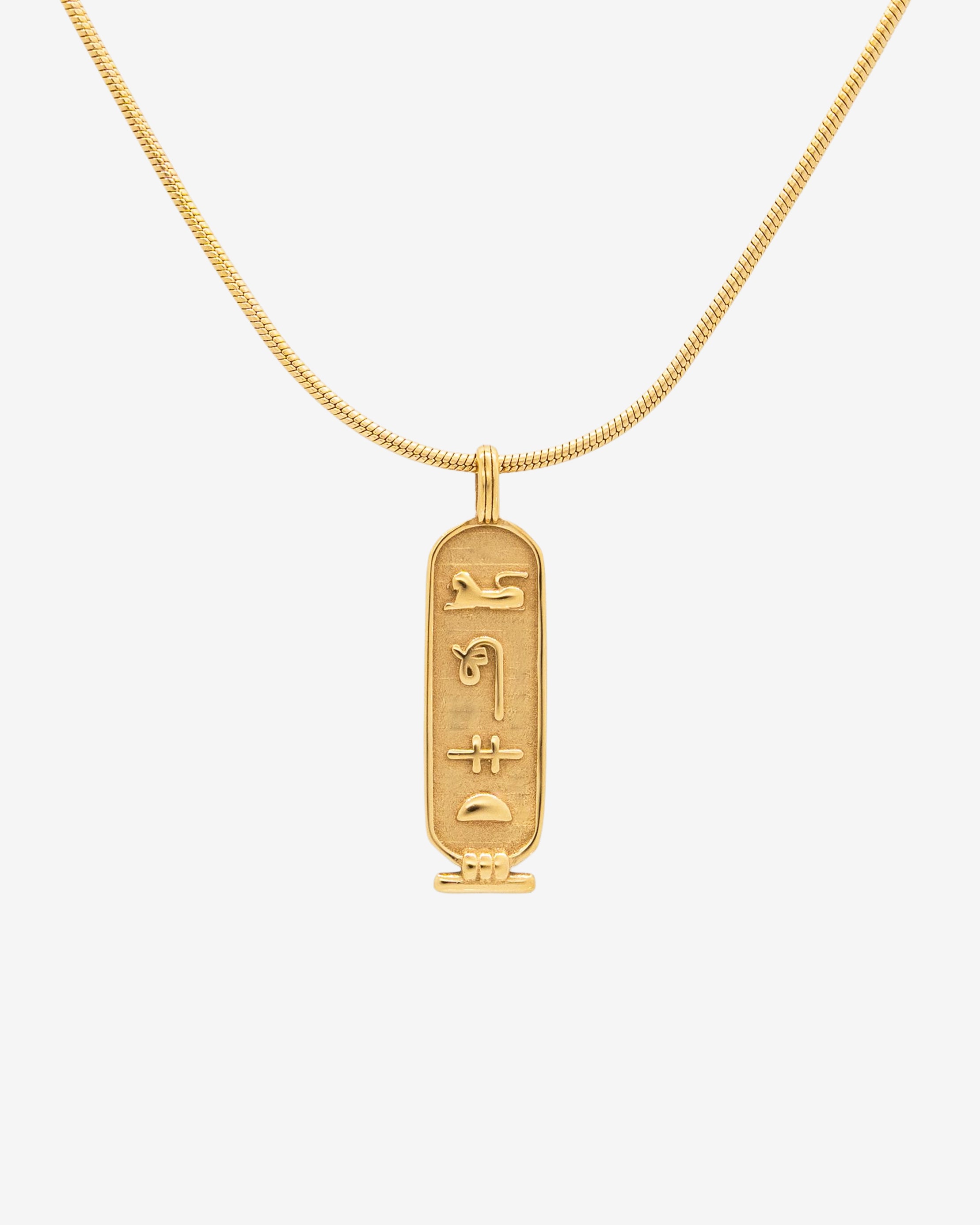 Luxor Gold Necklace close up with curved chain and rectangular pendant engraved with hieroglyphs