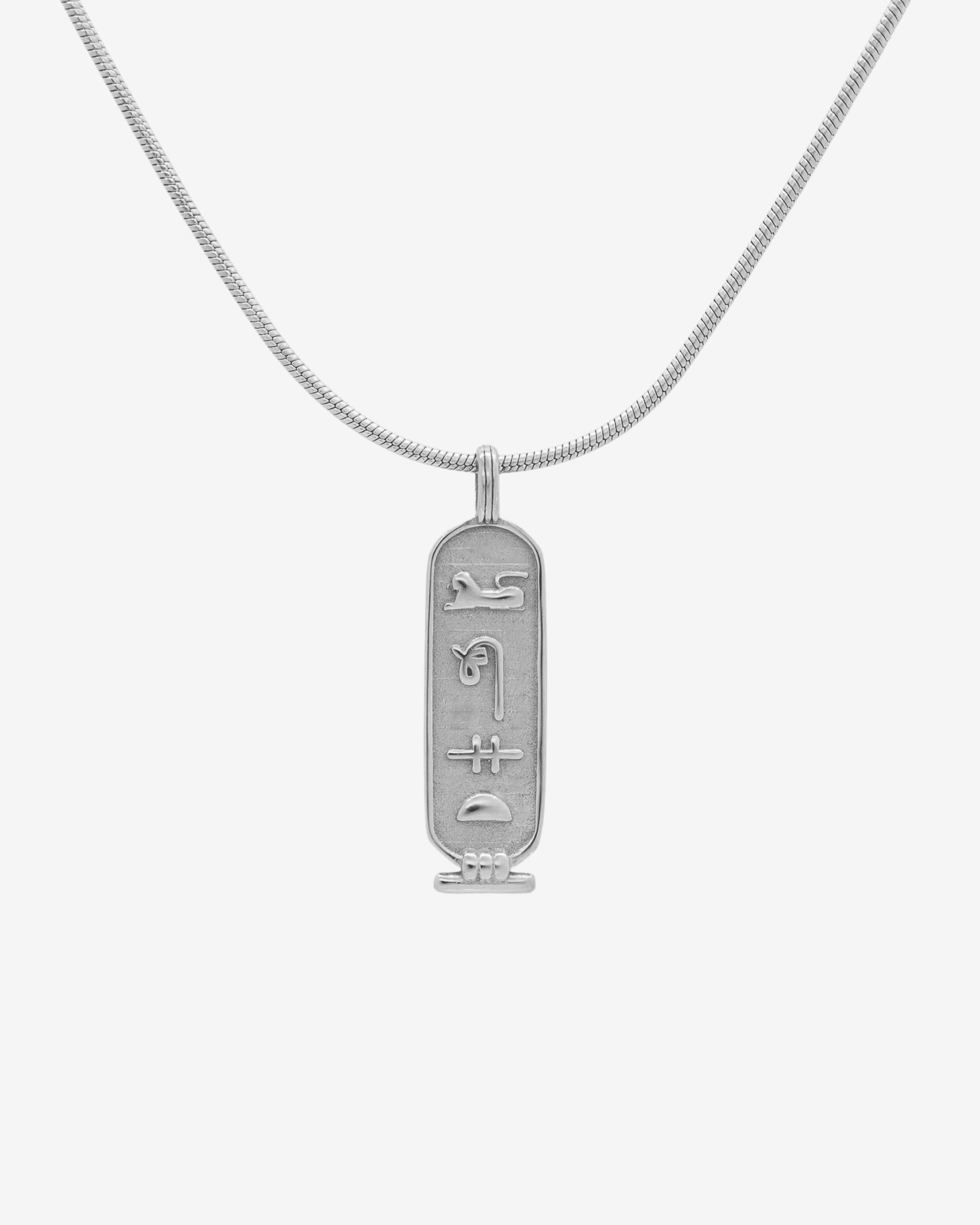 Luxor Silver Necklace worn around the neck with a rectangular pendant featuring ancient glyphs