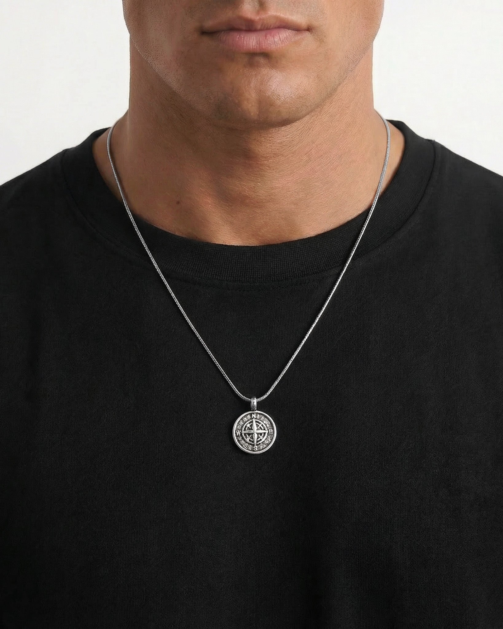 Model wears MOJAVE compass pendant necklace on a silver chain around the neck