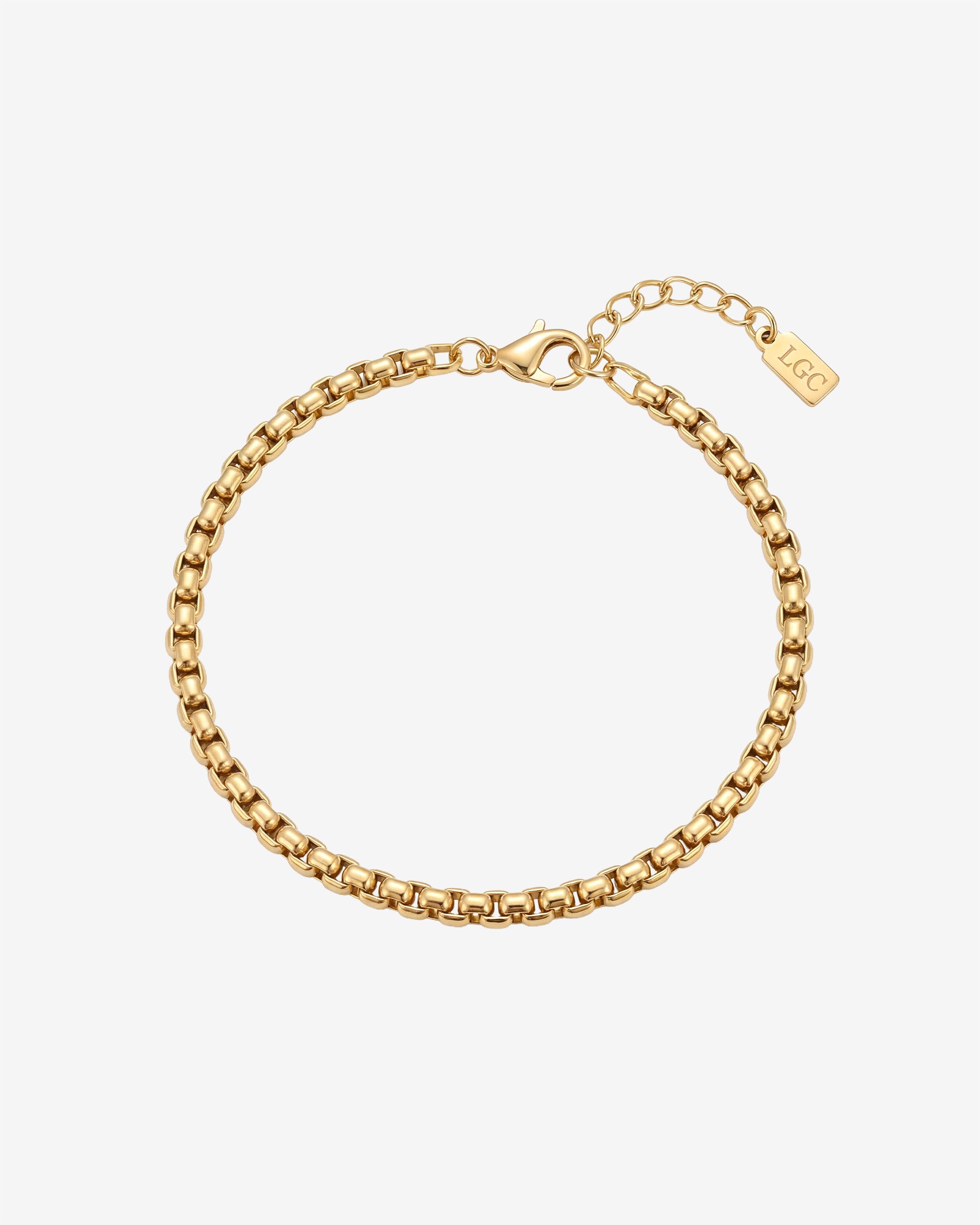 Noir Gold Bracelet close up showing chain links and a lobster clasp on a pale background