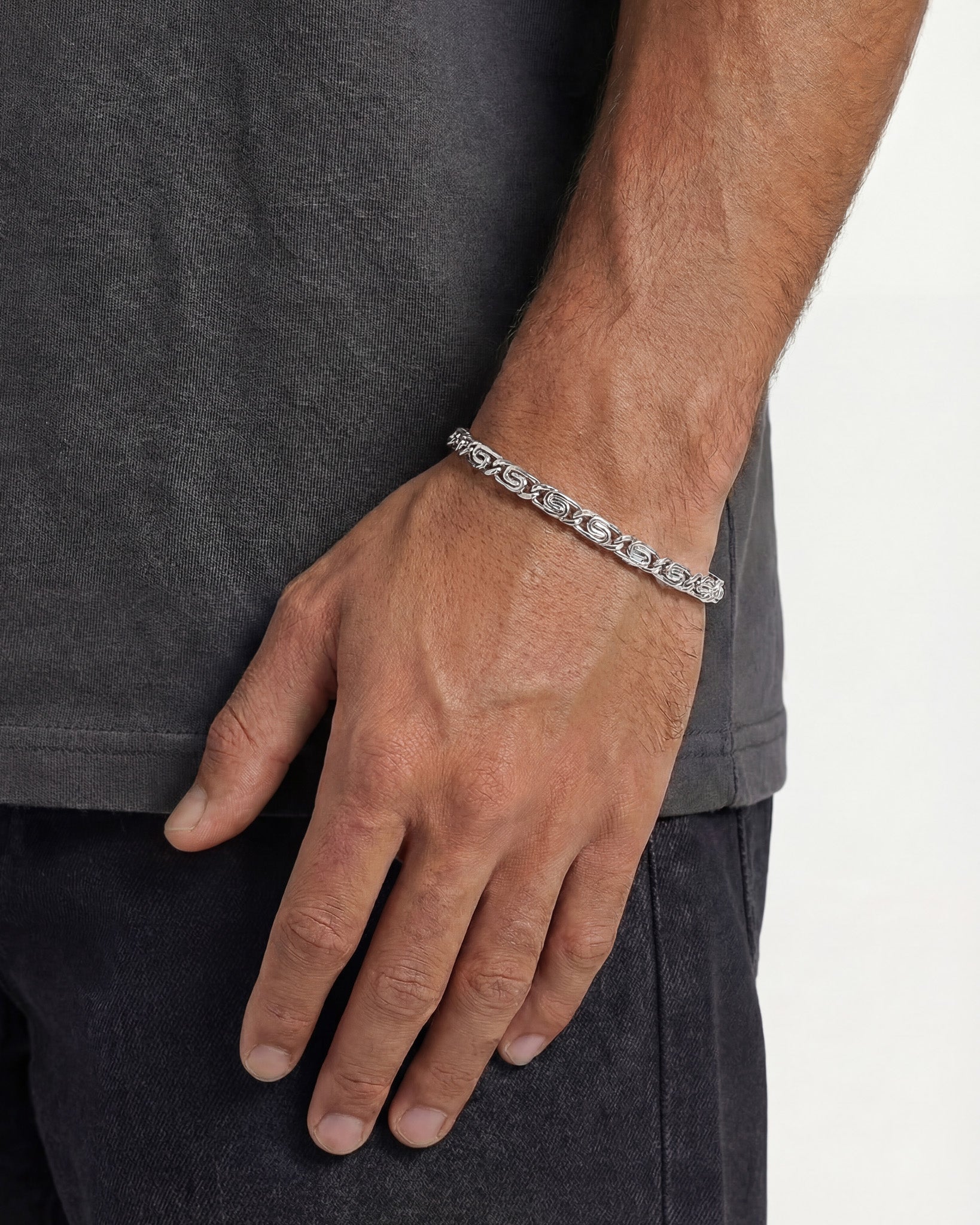 NUSA SILVER BRACELET worn on a man's wrist showing a bold linked pattern