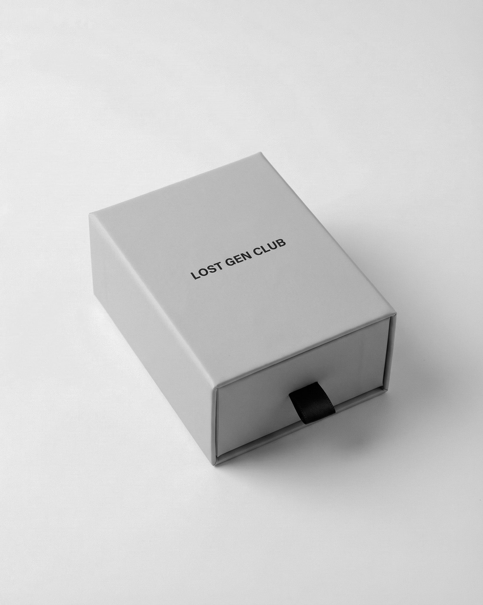 Grey drawer box packaging with Lost Gen Club label