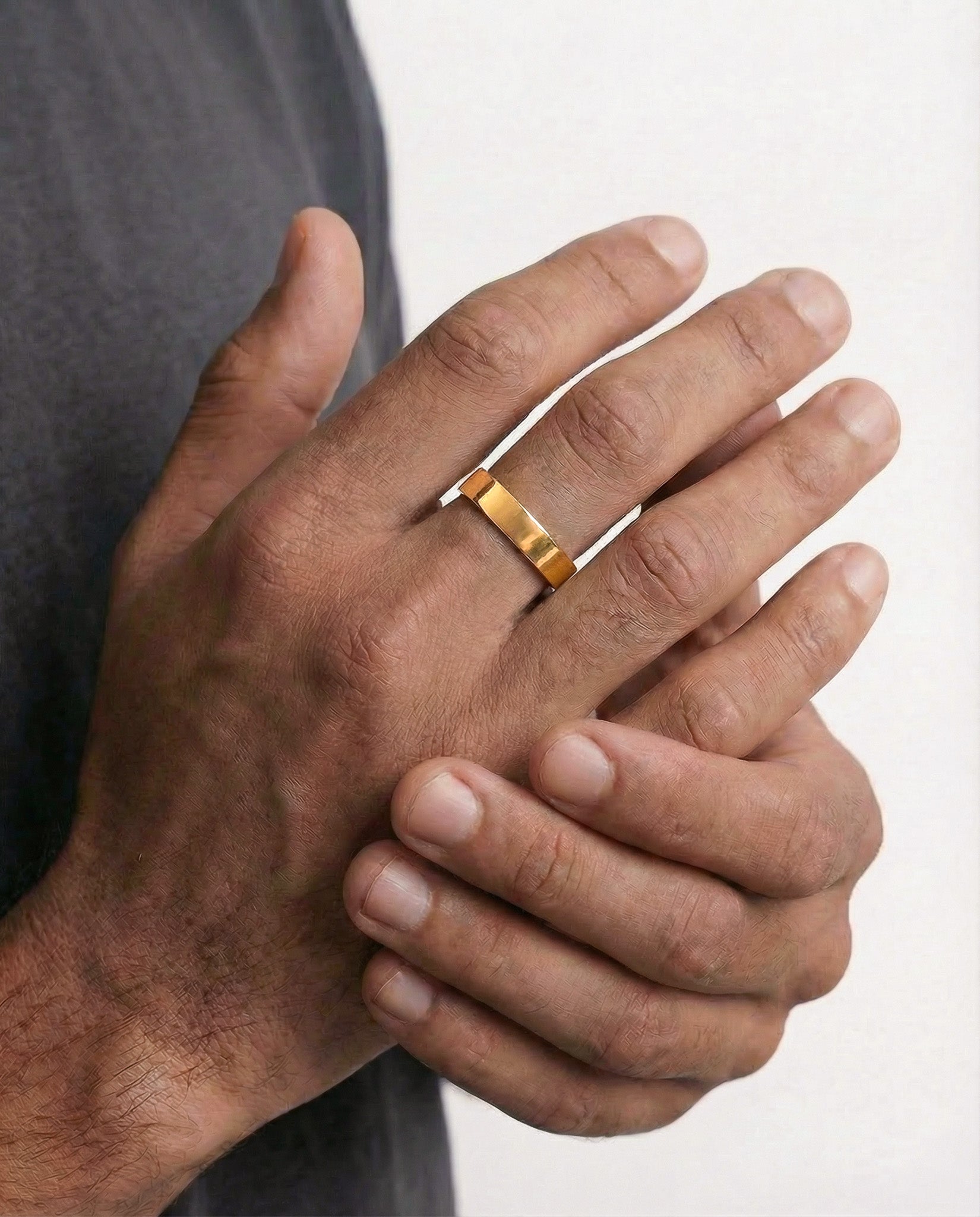 Slim adjustable gold ring on finger, 4 mm wide